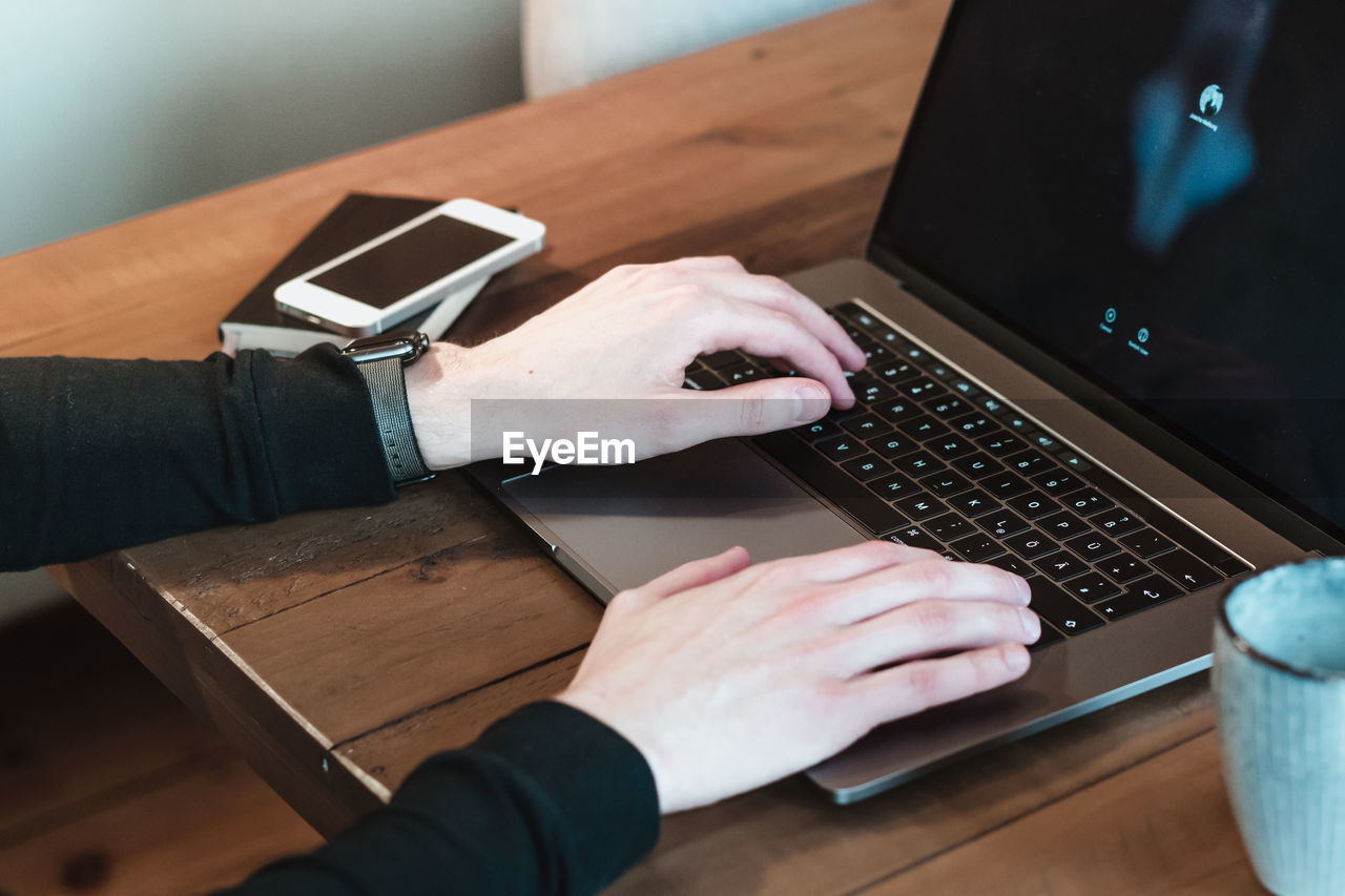 Midsection of man using laptop