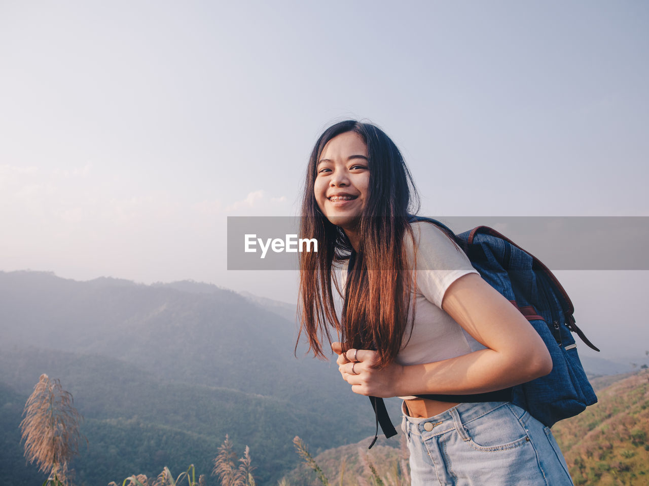Wanderlust and travel concept from happy asian young woman walking trail in mountain
