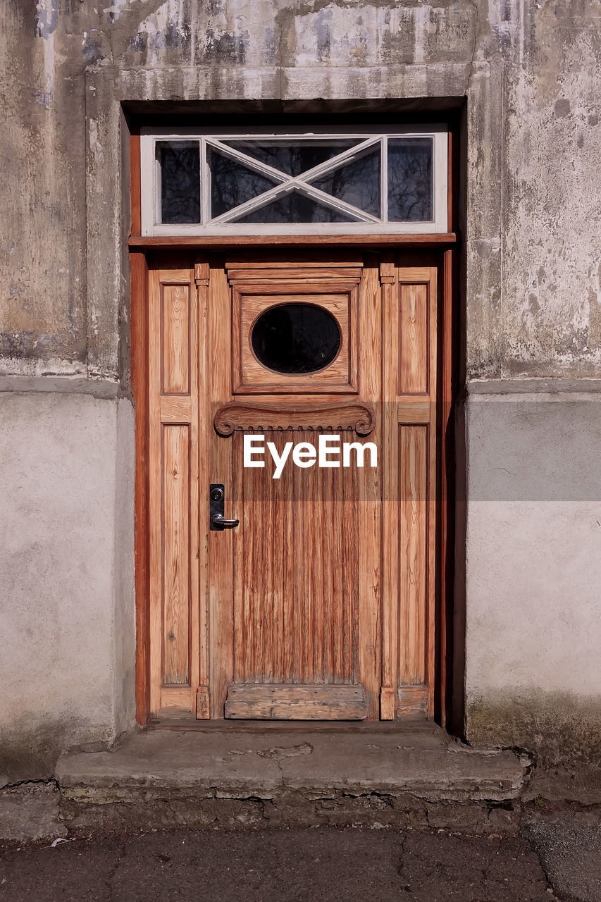 An old door with an oval shaped window at tallinn, estonia. 