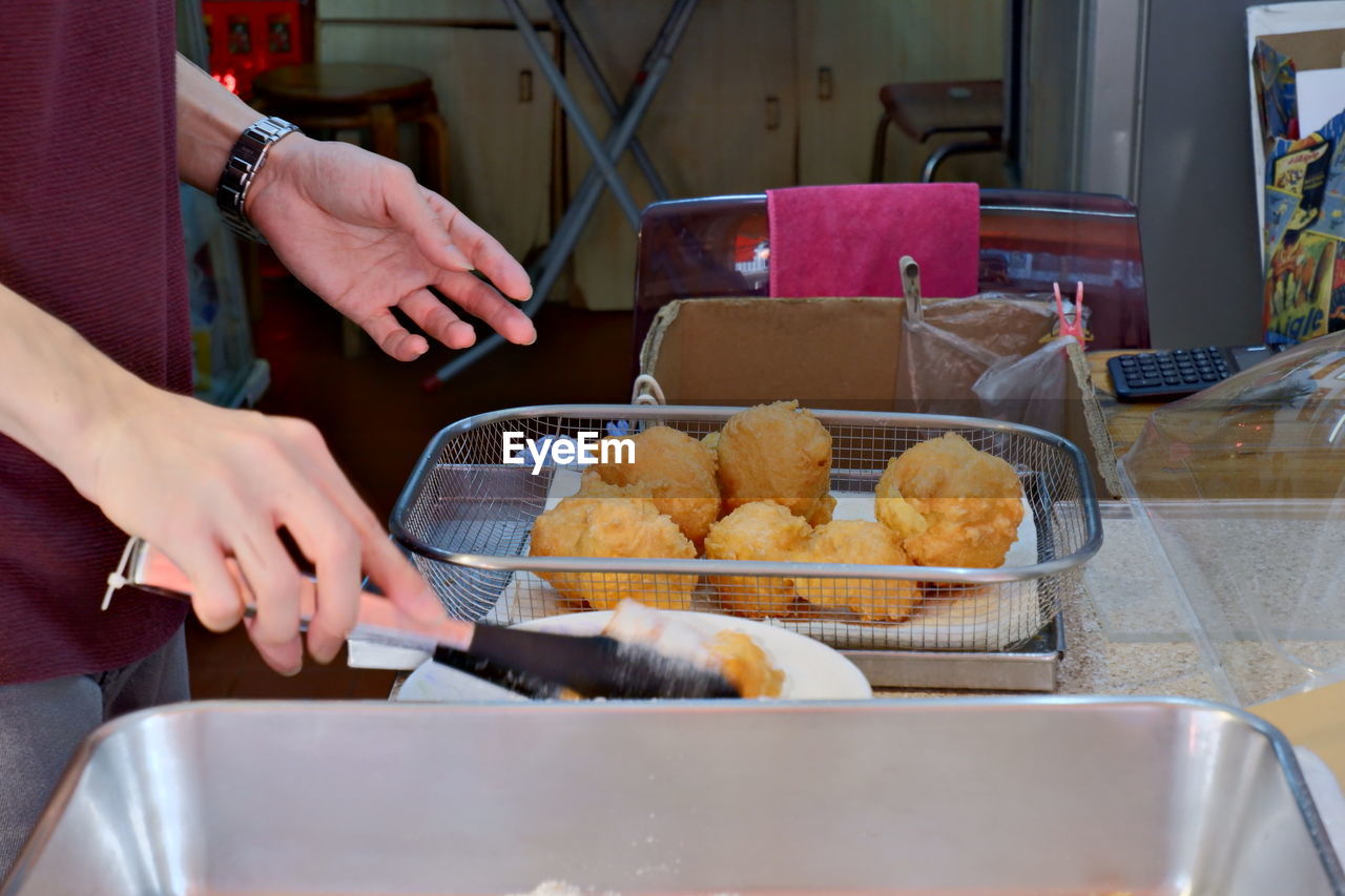 Midsection of man preparing food