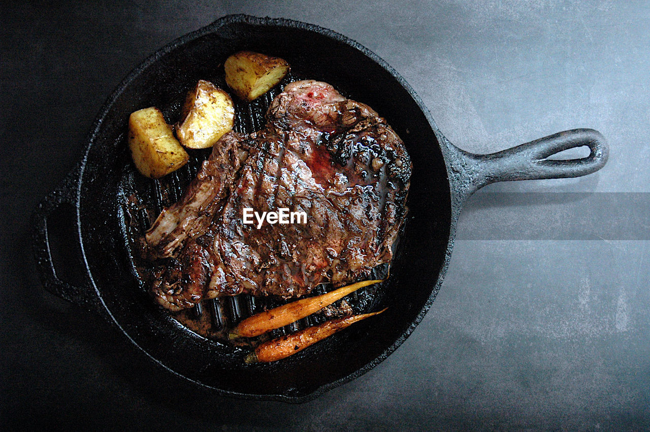 High angle view of steak in cooking pan