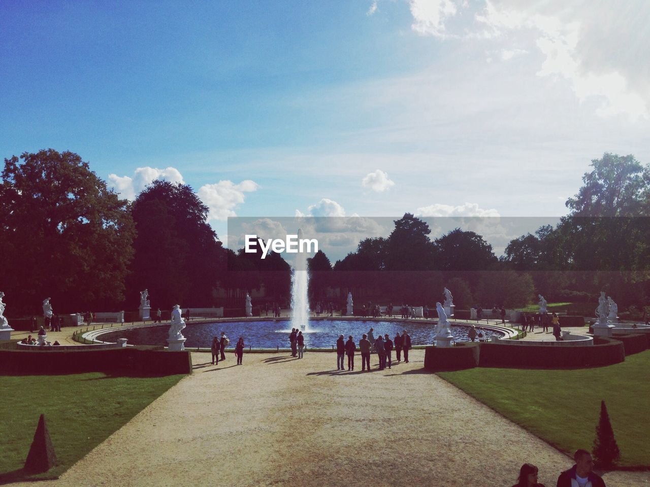 Group of people by fountain in the park