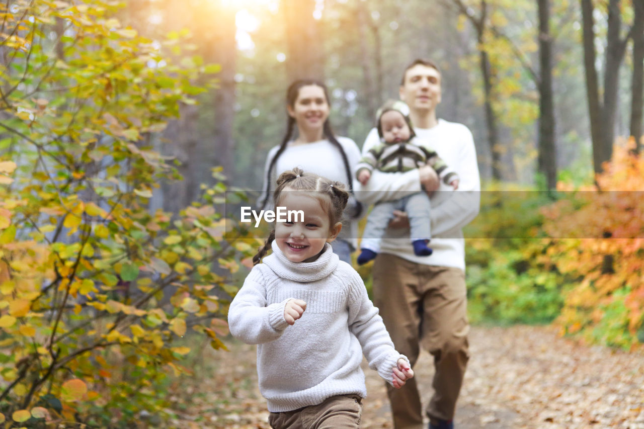 Cheerful family waking at park