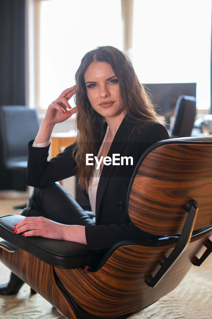 Portrait of smiling woman sitting on chair