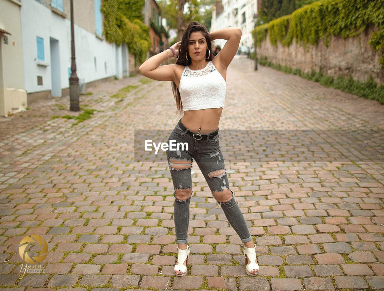 FULL LENGTH PORTRAIT OF A WOMAN STANDING ON FOOTPATH