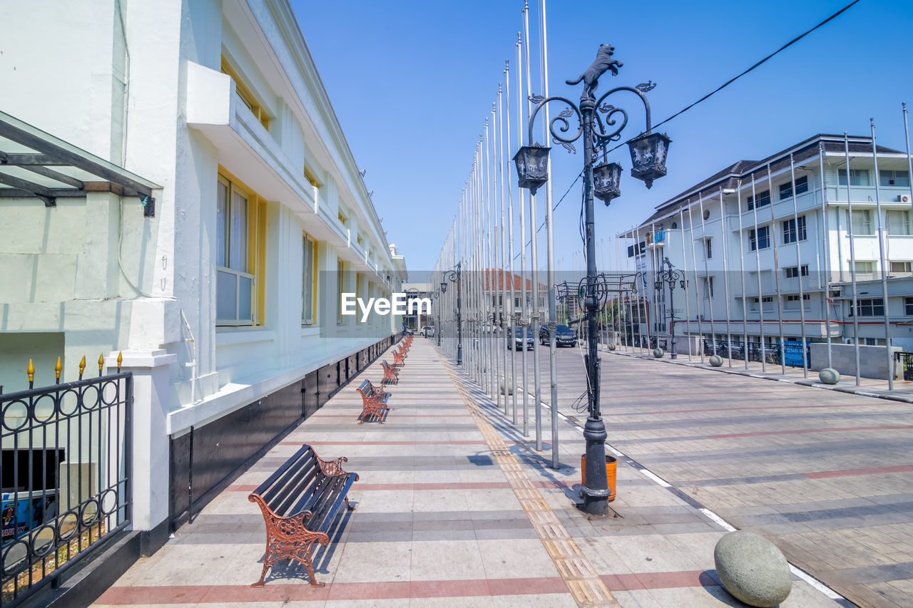 Street amidst buildings against sky in city