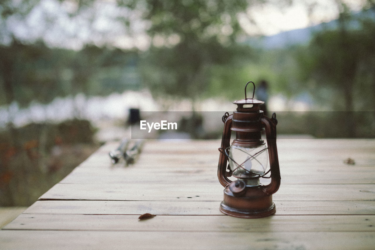 Close-up of lantern on wooden table