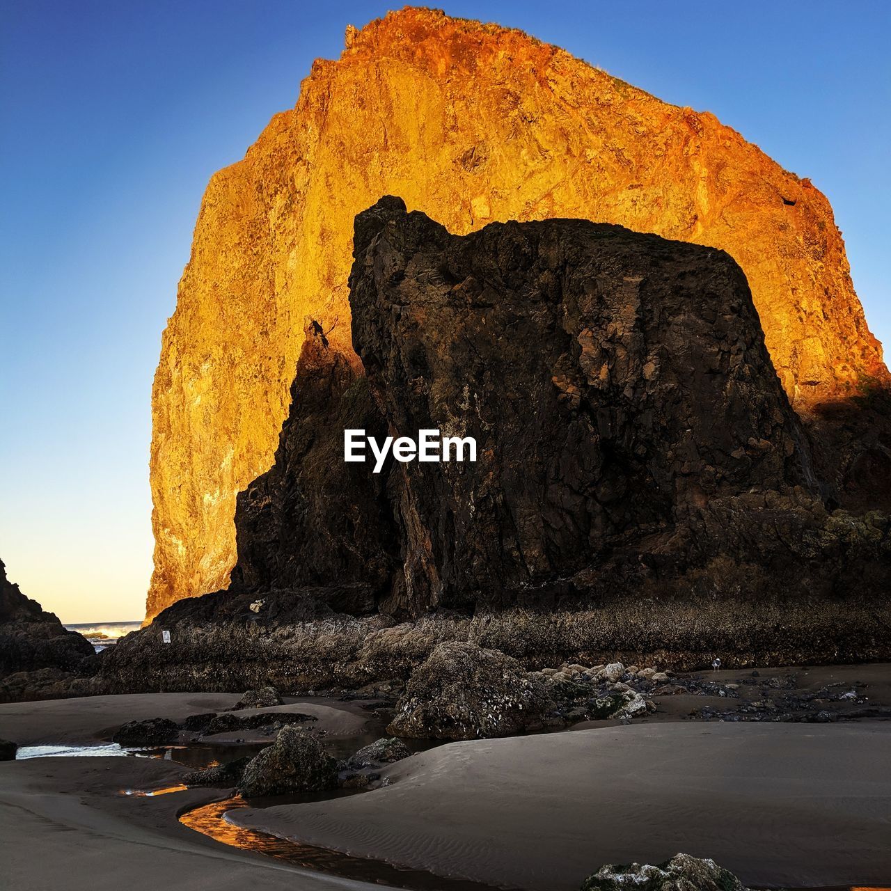 ROCK FORMATION IN SEA AGAINST SKY