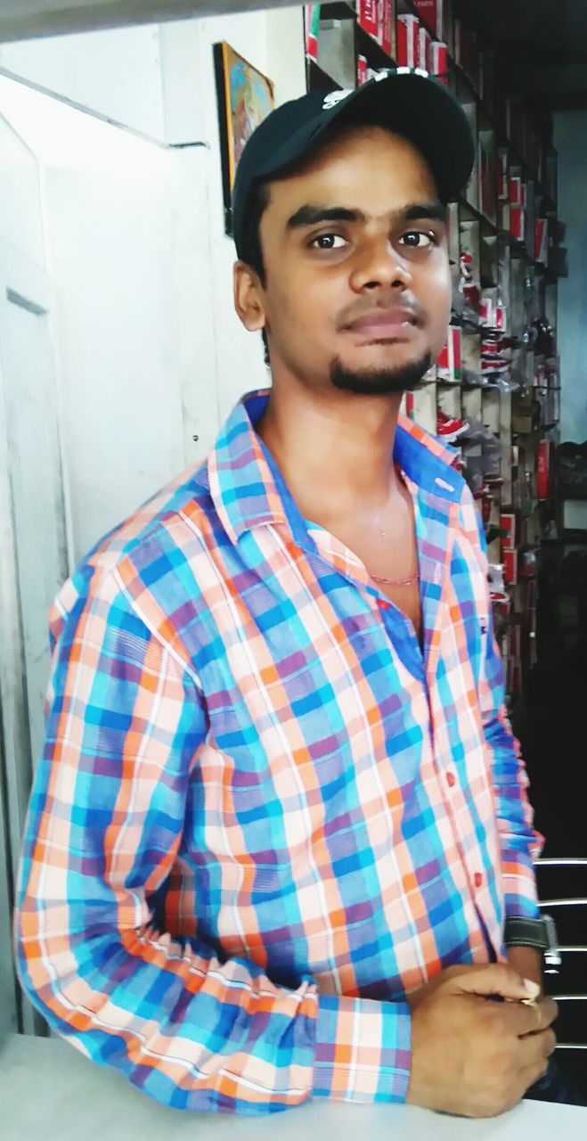 Portrait of young man standing in workshop