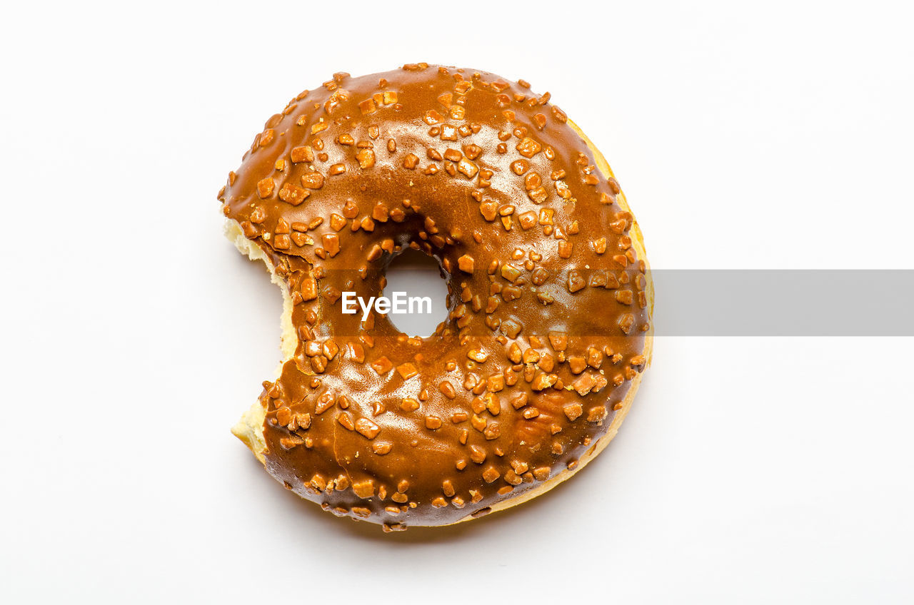 Close-up of donut over white background