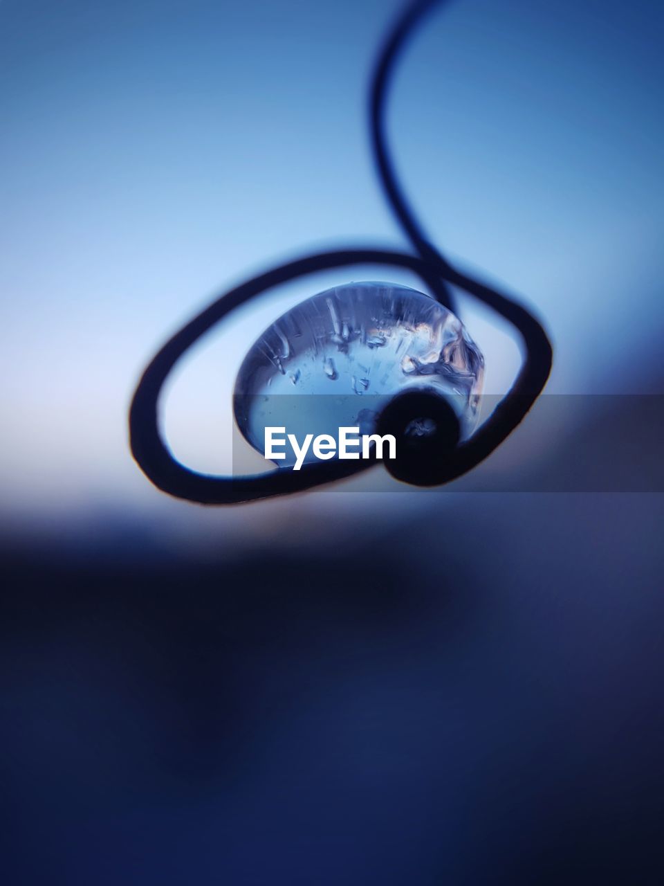 Close-up of frozen water drop on metal 