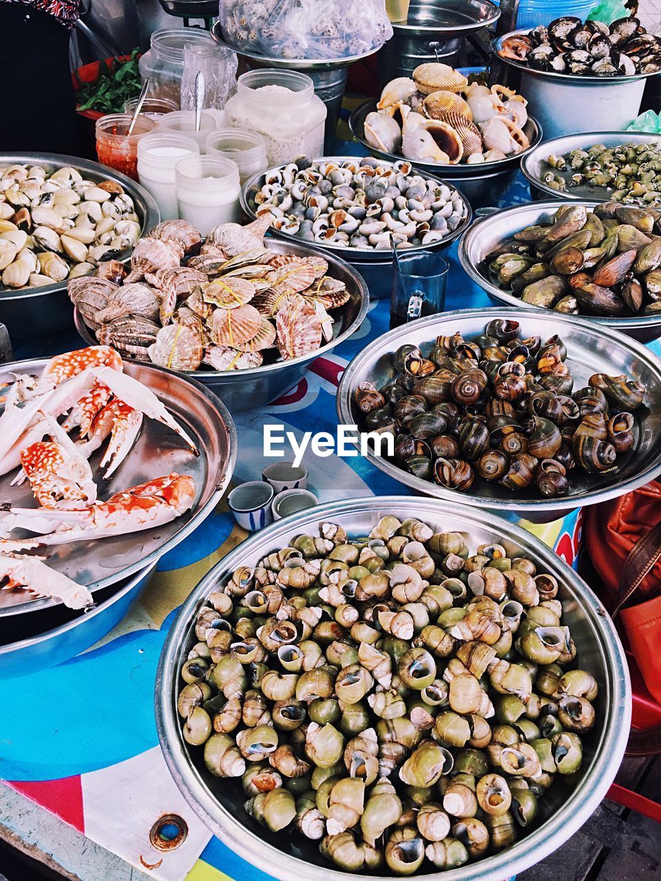 High angle view of various seafood in containers for sale at street market