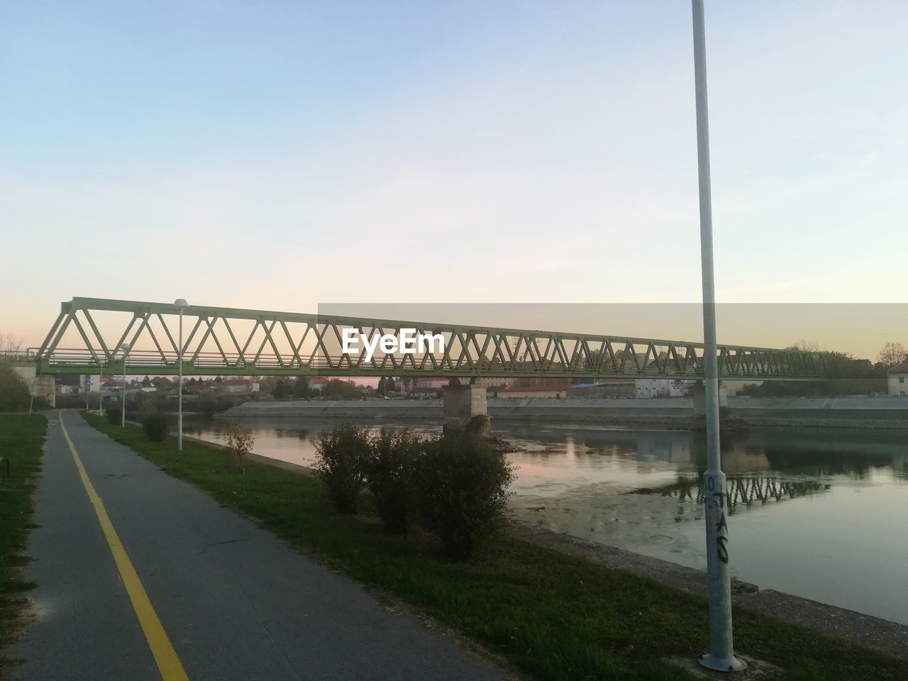 VIEW OF SUSPENSION BRIDGE OVER RIVER AGAINST SKY