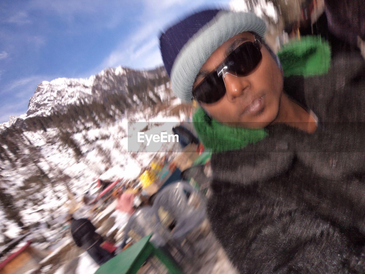 YOUNG MAN WITH SUNGLASSES IN WINTER