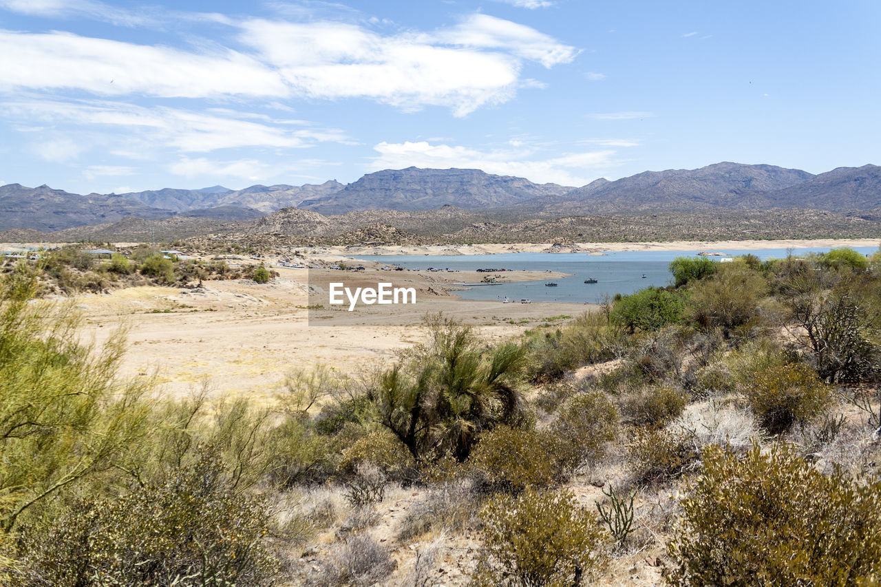 Scenic view of land and mountains against sky