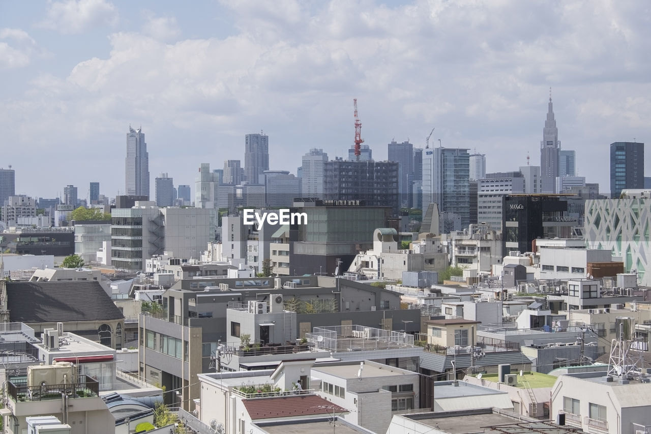 View of cityscape against cloudy sky