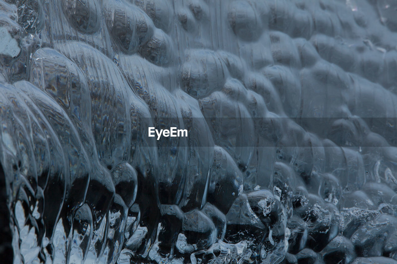 CLOSE-UP OF ICICLES ON LAND