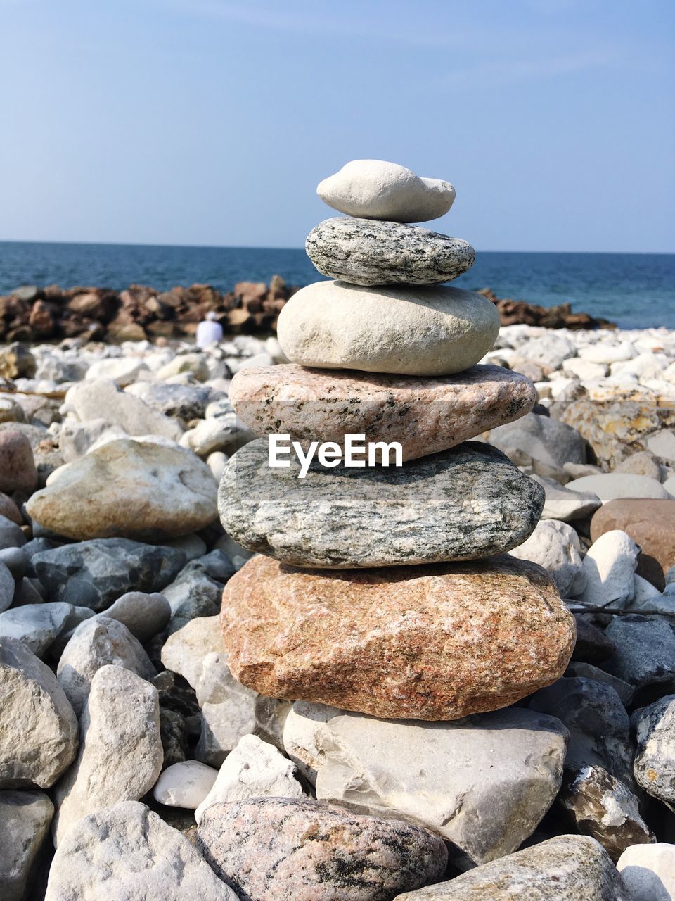 STACK OF STONES ON SHORE AT BEACH