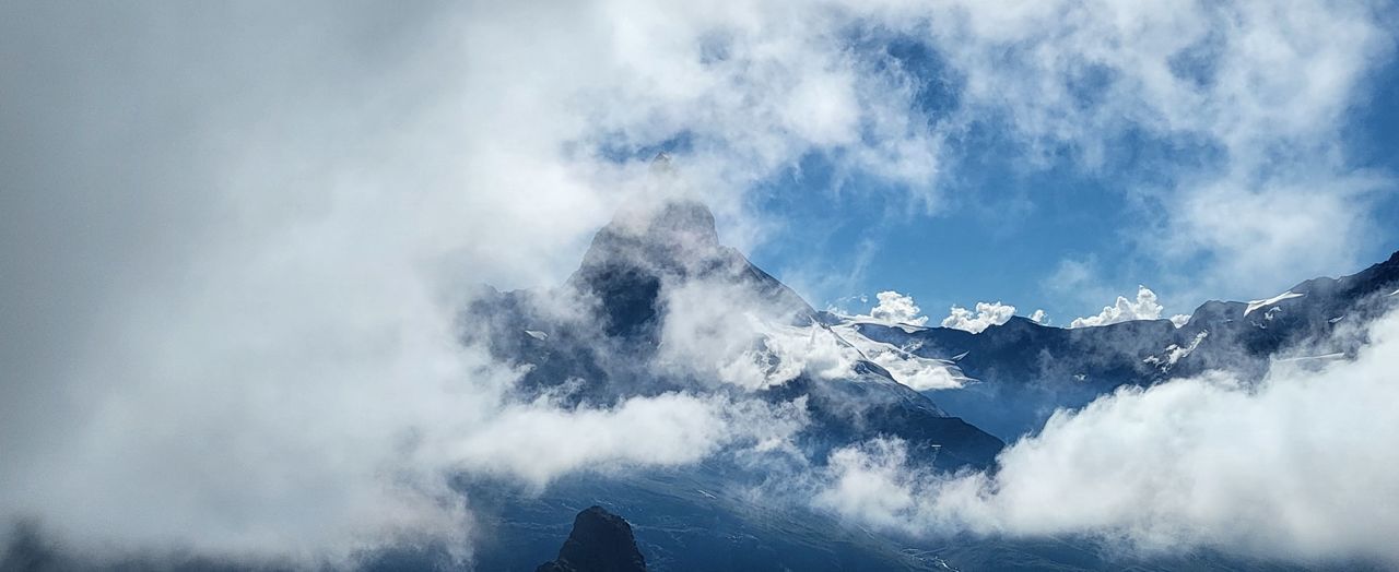 cloud, mountain, beauty in nature, environment, scenics - nature, sky, cold temperature, landscape, snow, mountain range, nature, winter, panoramic, fog, no people, travel, travel destinations, mountain peak, outdoors, land, non-urban scene, day, blue, ice, tranquility, snowcapped mountain, tranquil scene