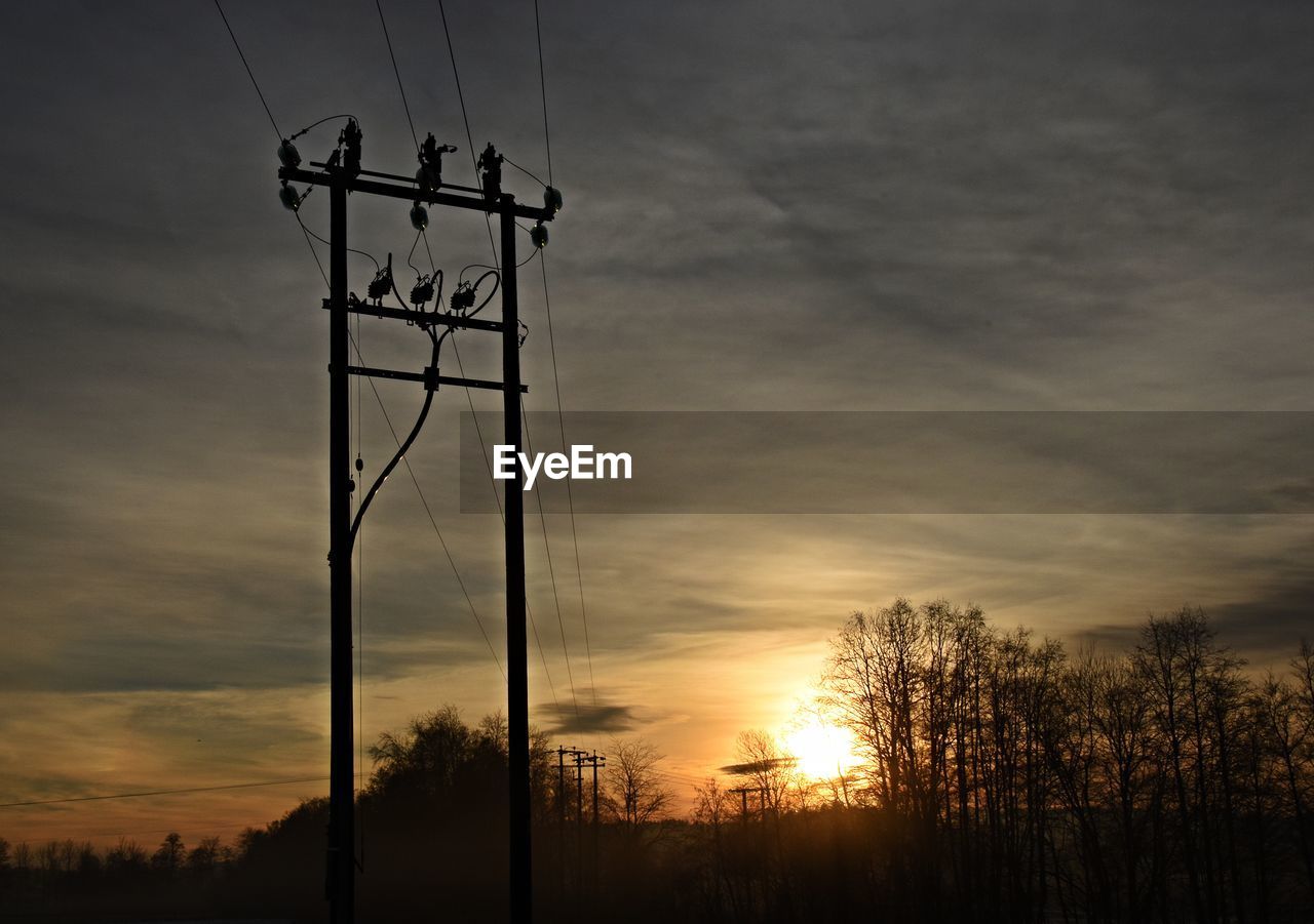 SILHOUETTE ELECTRICITY PYLON AGAINST SKY DURING SUNSET