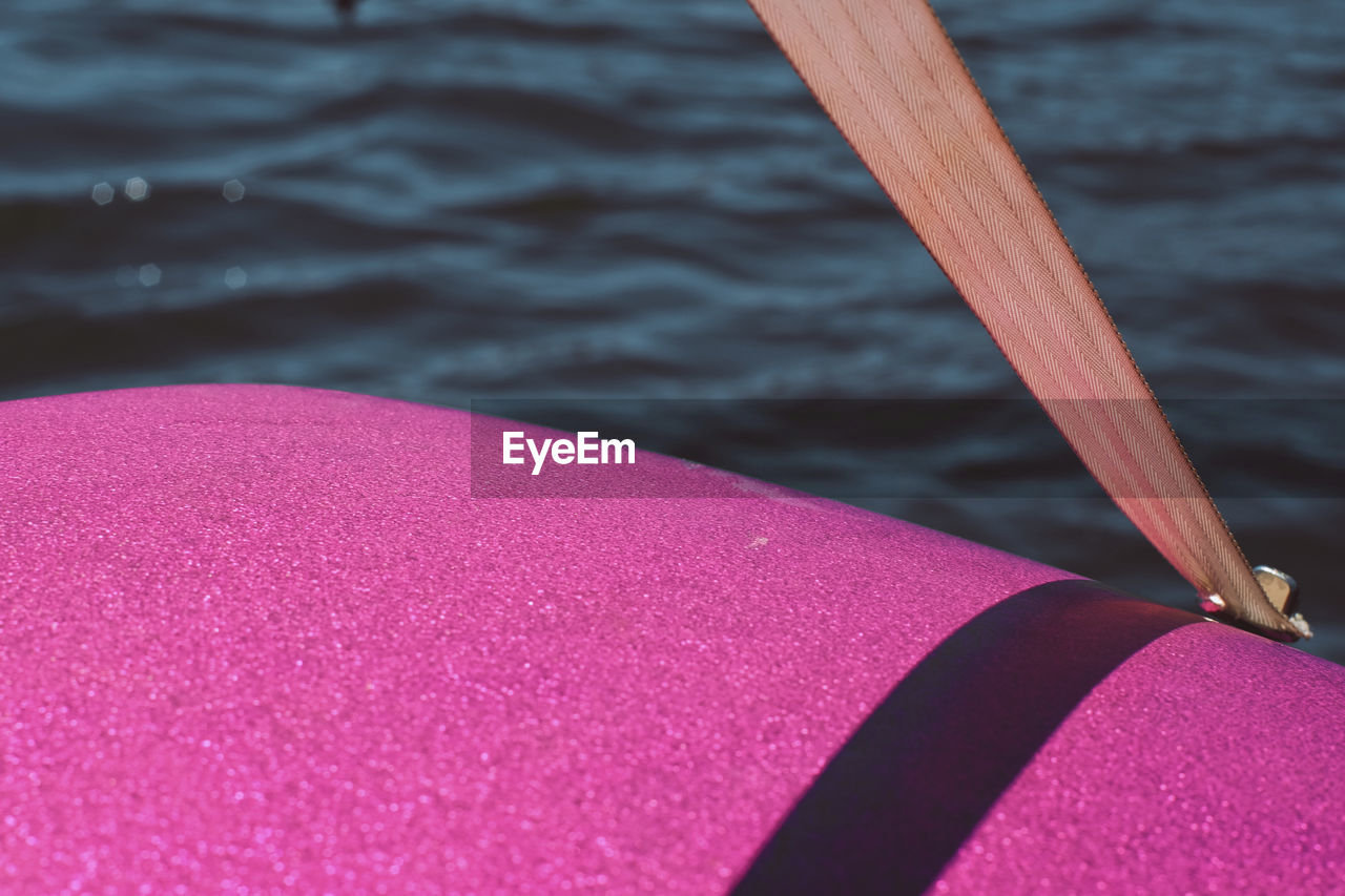 Cropped image of pink pedal boat on sea