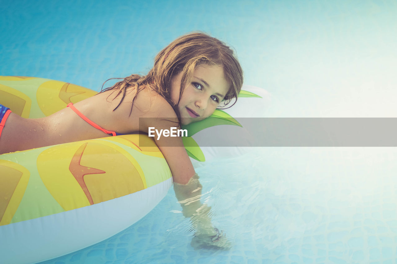 Portrait of girl swimming in pool