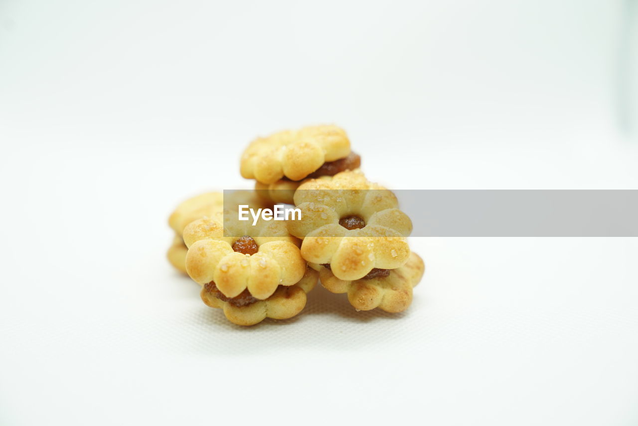 Close-up of small desserts against white background