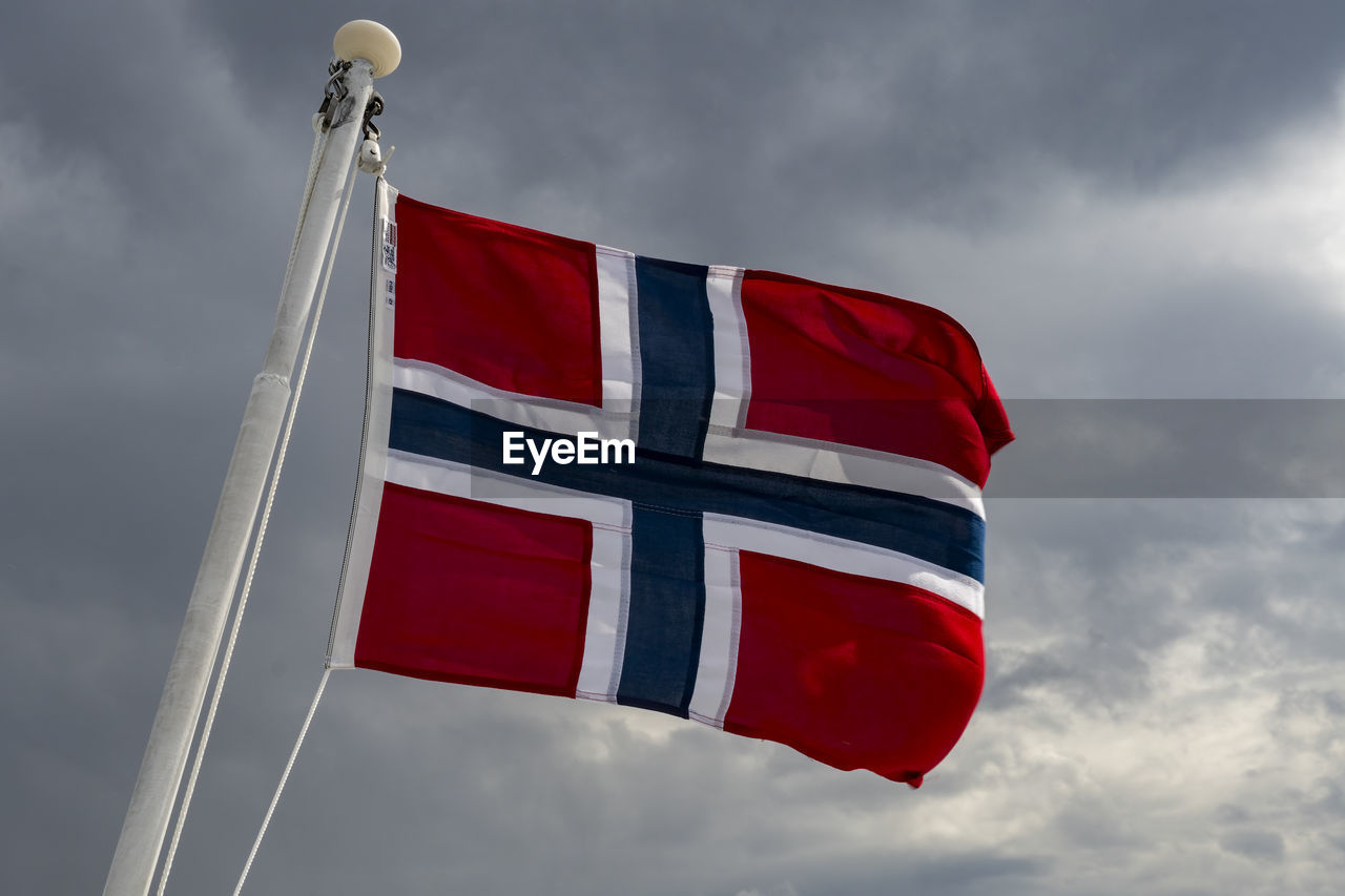 cloud, sky, red, flag, patriotism, nature, environment, low angle view, wind, no people, day, outdoors, pole, symbol, striped, white, blue