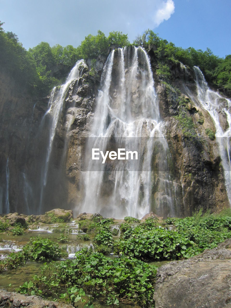 Low angle view of waterfall against the sky