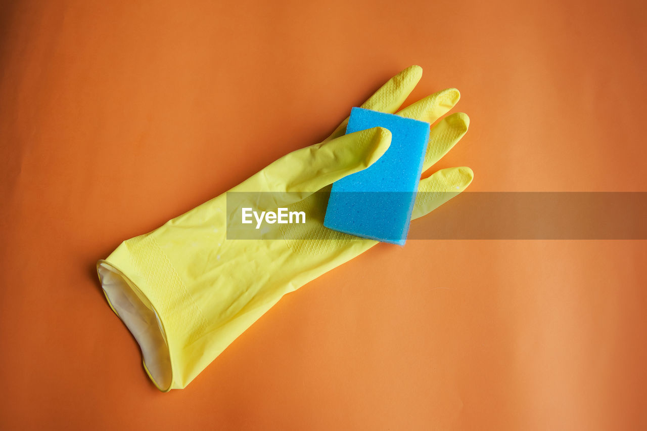 High angle view of glove and sponge on table