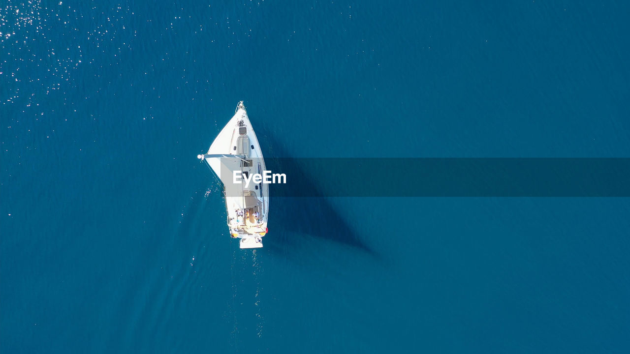 Sailboat sailing in sea against clear sky