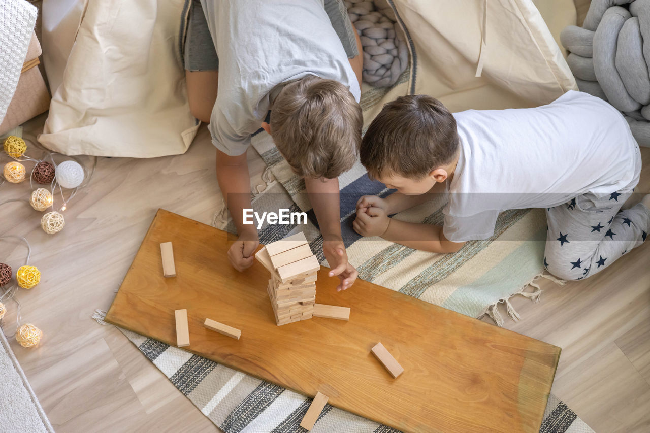 high angle view of mother and daughter sitting on table