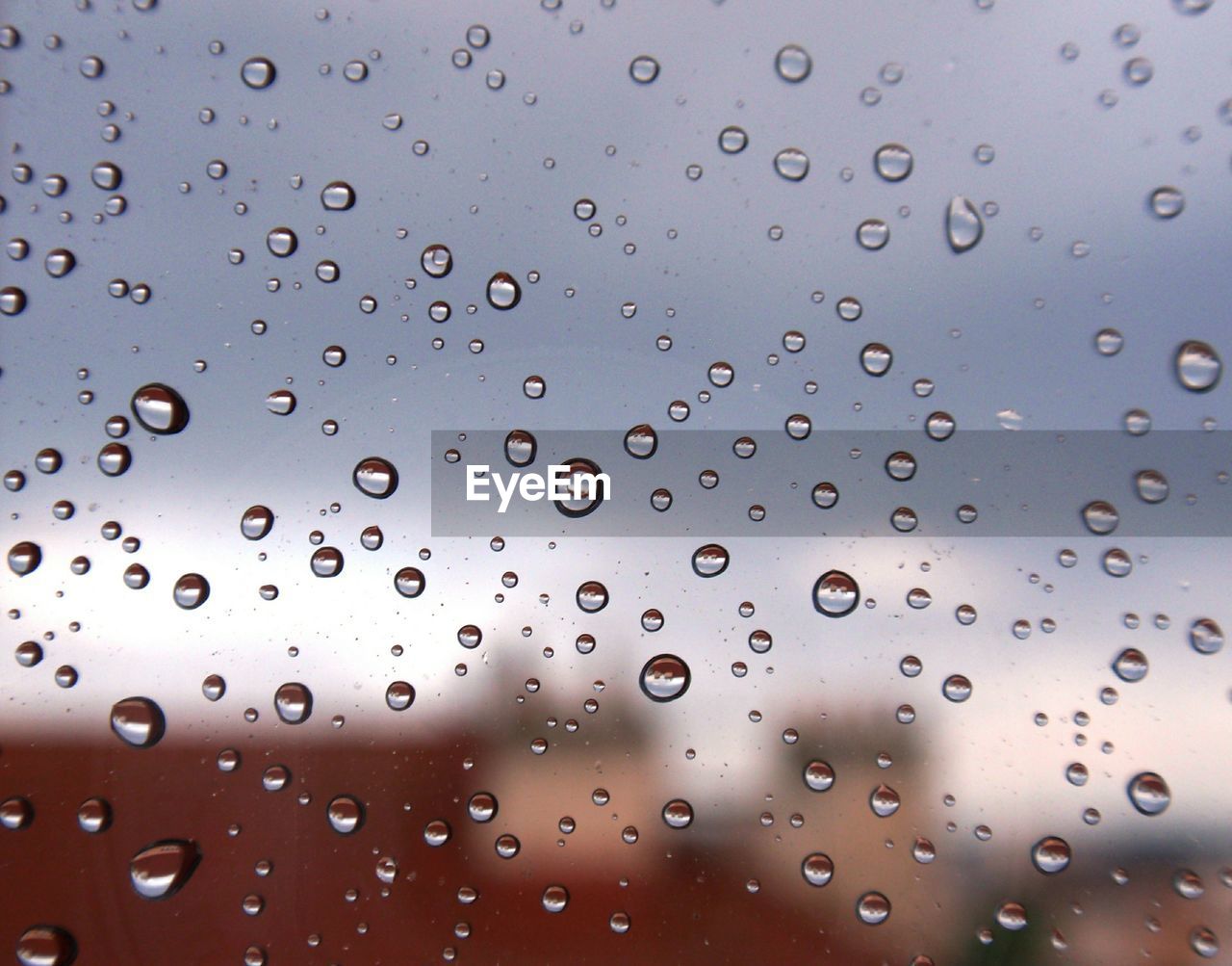 CLOSE-UP OF RAINDROPS ON WINDOW