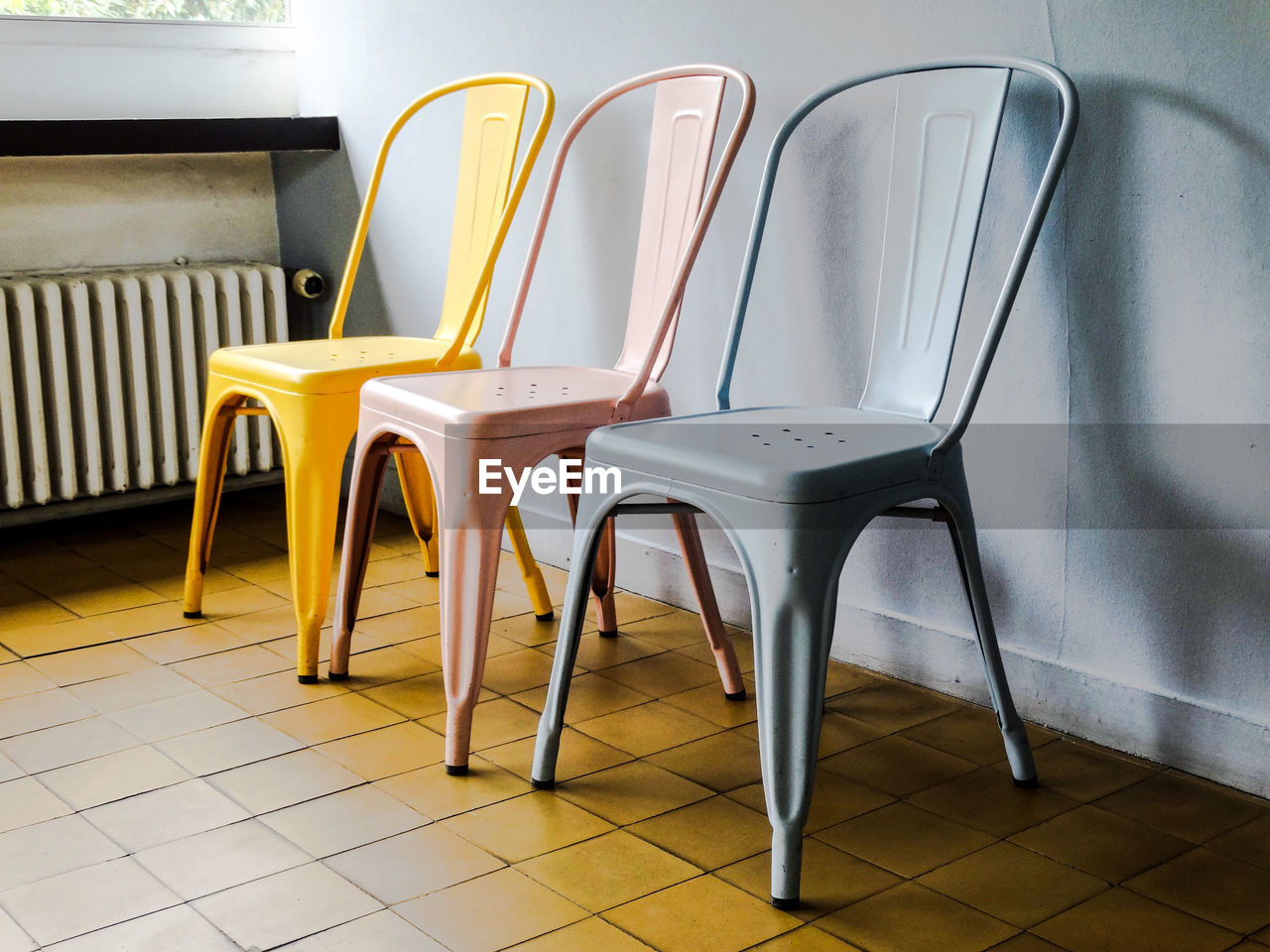 Empty chairs against tiled floor