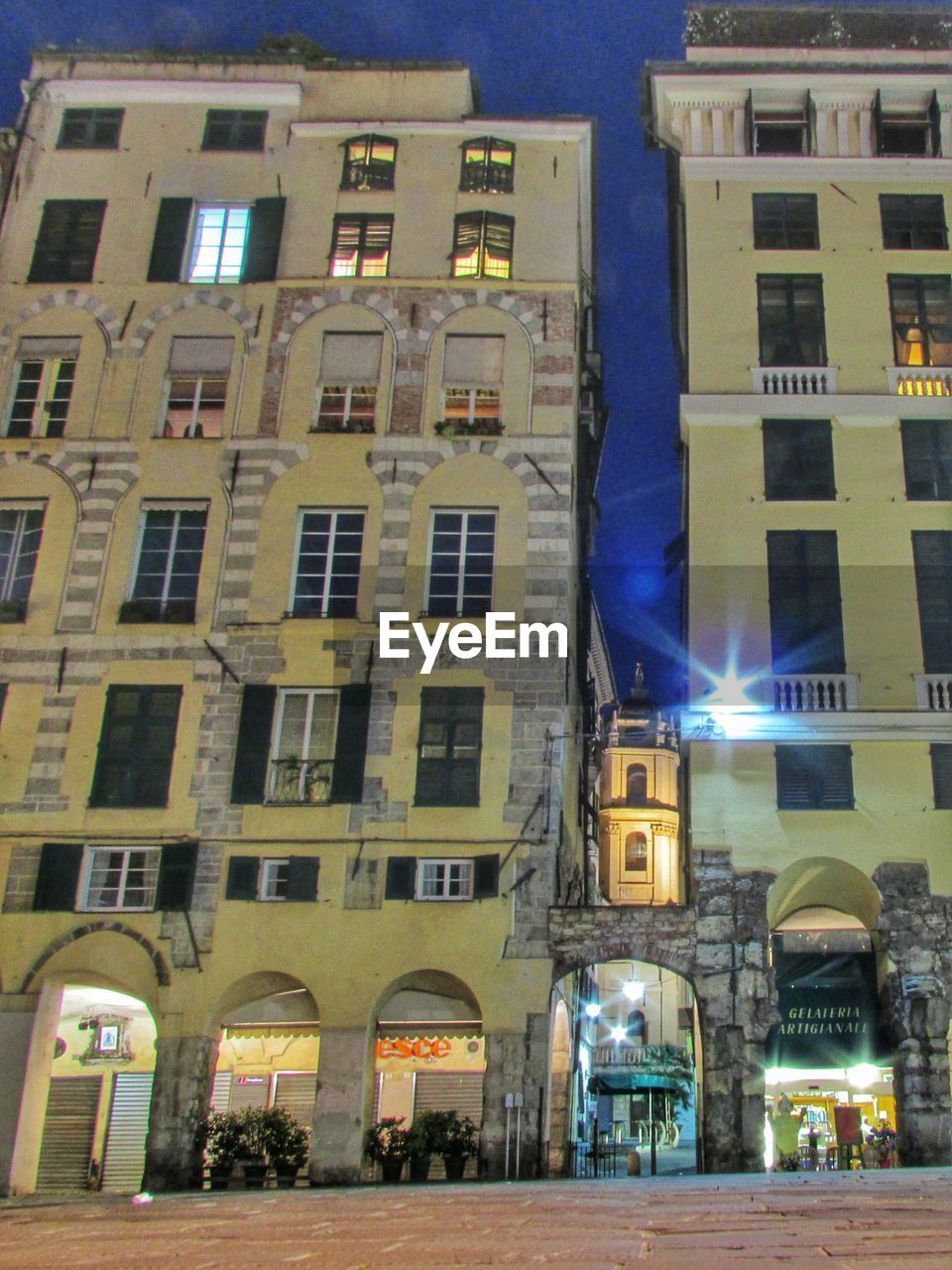 ILLUMINATED BUILDINGS IN CITY AT NIGHT