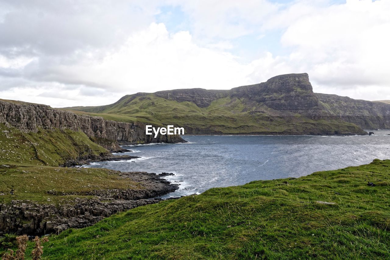 Scenic view of land and mountains against sky