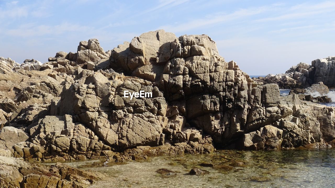 Rock formation amidst rocks against sky