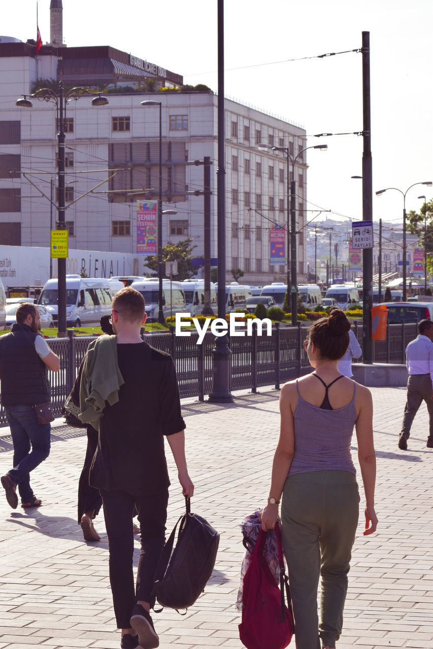 PEOPLE WALKING ON STREET IN CITY