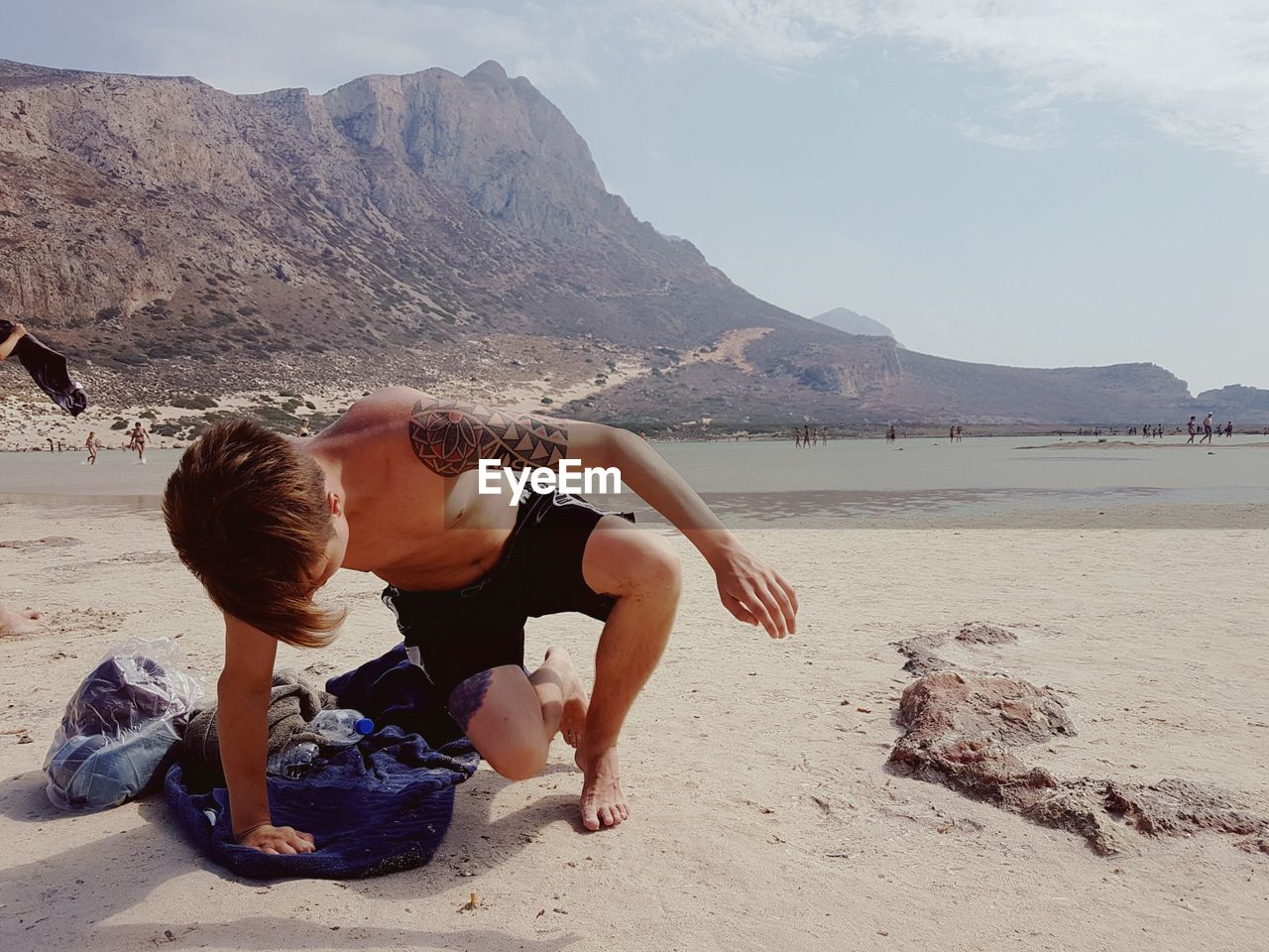 Shirtless boy on sea shore