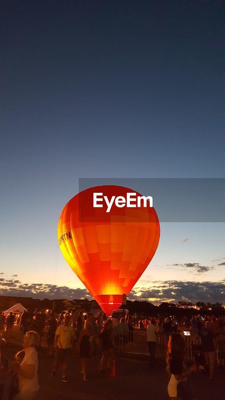 yellow, hot air balloon, red, balloon, light, reflection, sky, nature, no people, mid-air, flying, copy space, night, outdoors, vehicle, low angle view, aircraft, celebration, air vehicle, lighting, lighting equipment, transportation, lantern, blue, clear sky, event