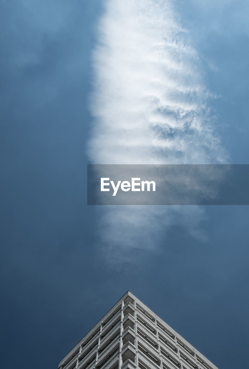 Low angle view of modern building against blue sky