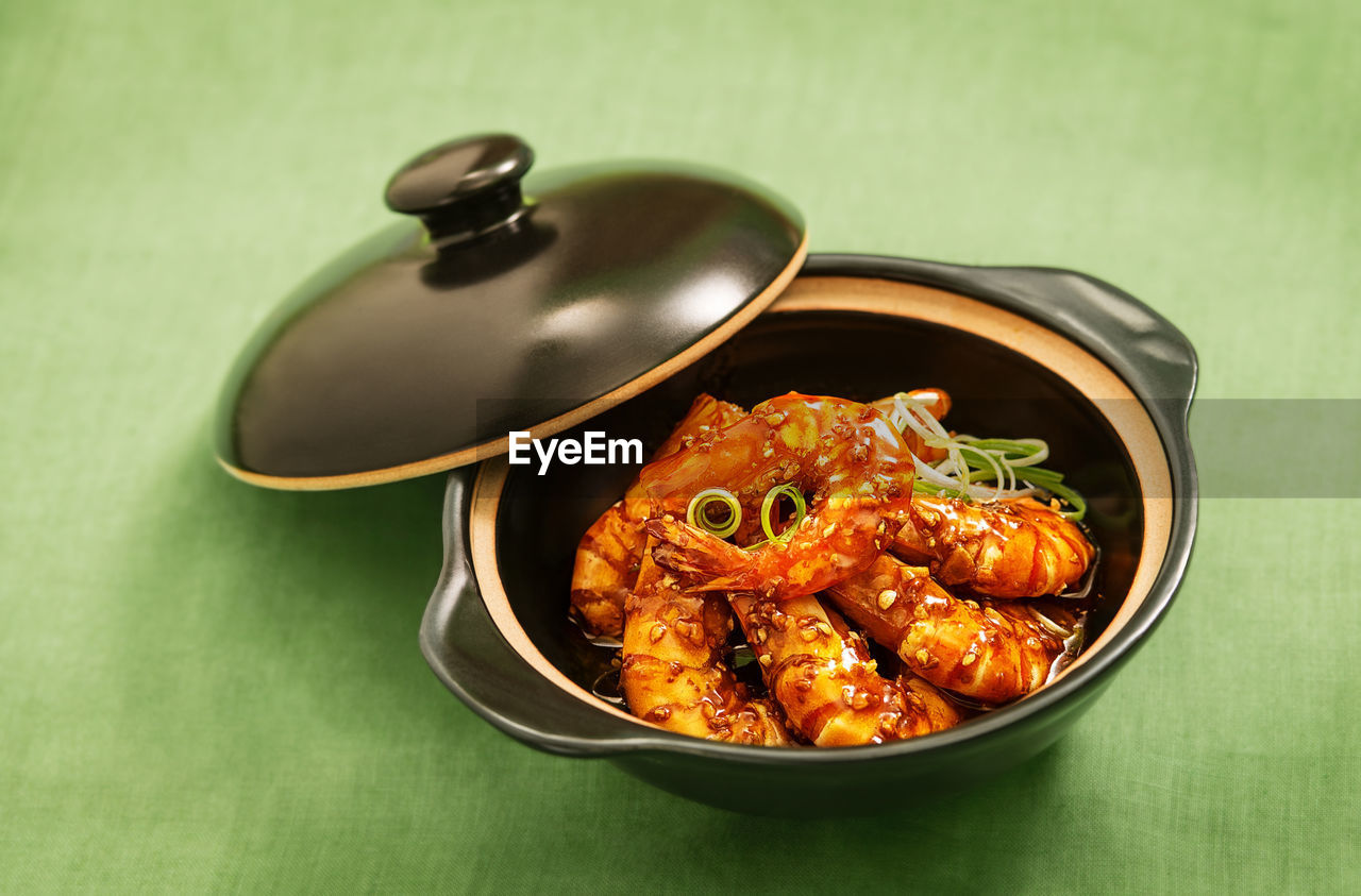 Close-up of prawns in casserole on table