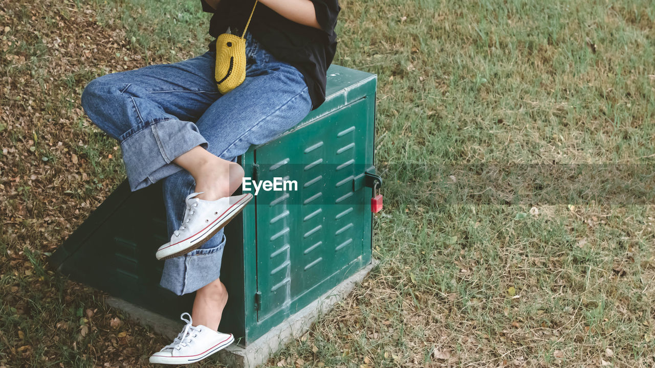 LOW SECTION OF MAN HOLDING BOOK