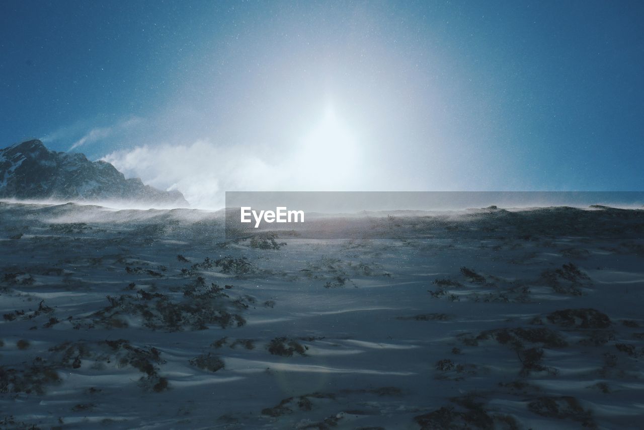 Scenic view of snow covered landscape against clear sky