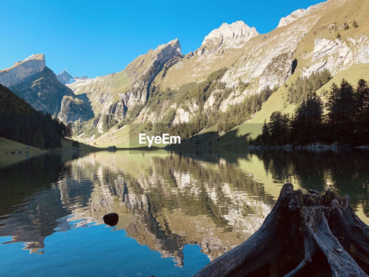 Scenic view of lake and mountains against clear sky