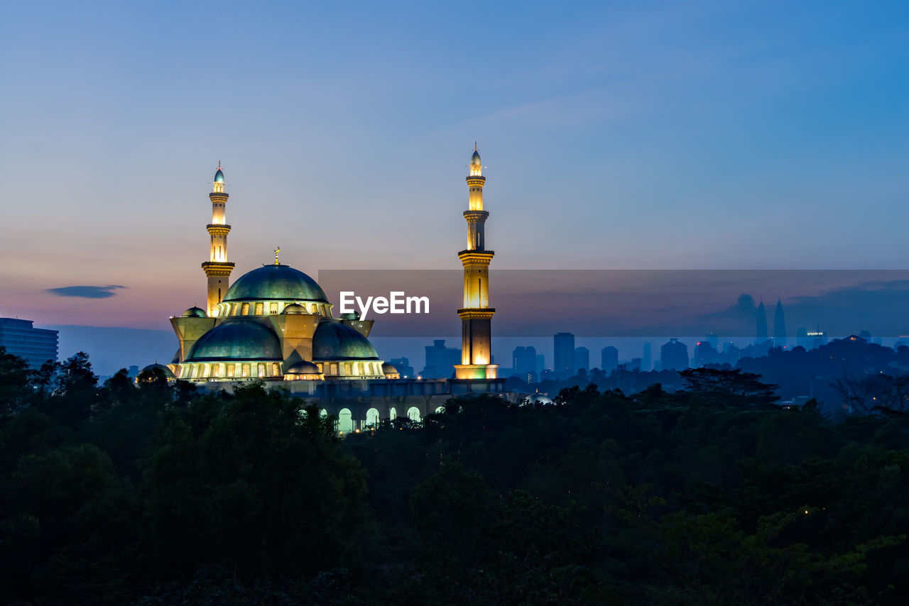 Federal territory mosque against sky during sunset