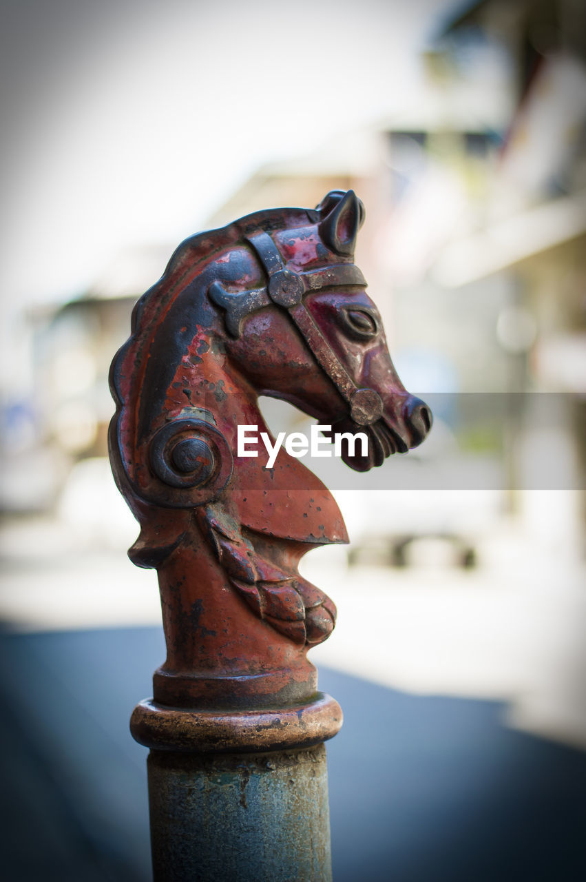 Close-up of metallic horse ornate in city