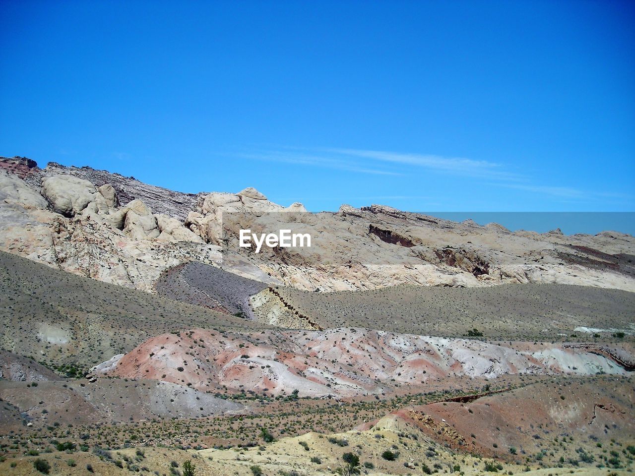 SCENIC VIEW OF MOUNTAIN AGAINST BLUE SKY