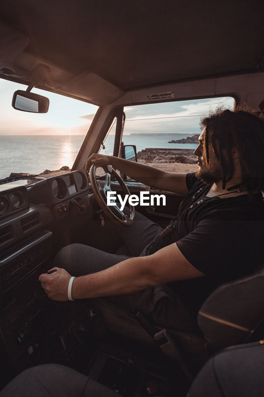 Rear view of woman sitting in car