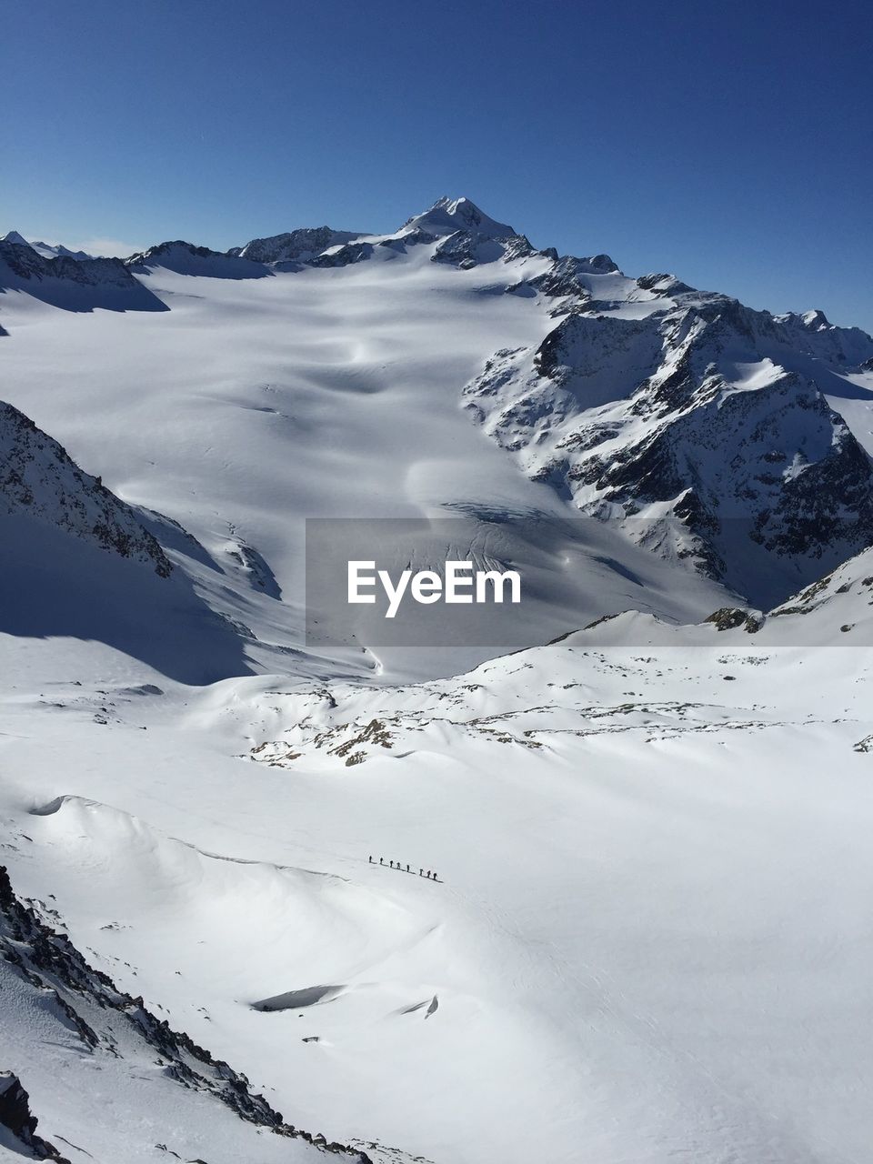 Climbers crossing an alpine glacier